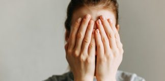 Scared girl covering face